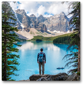 Single photo printed on wood of a man looking at a mountain lake